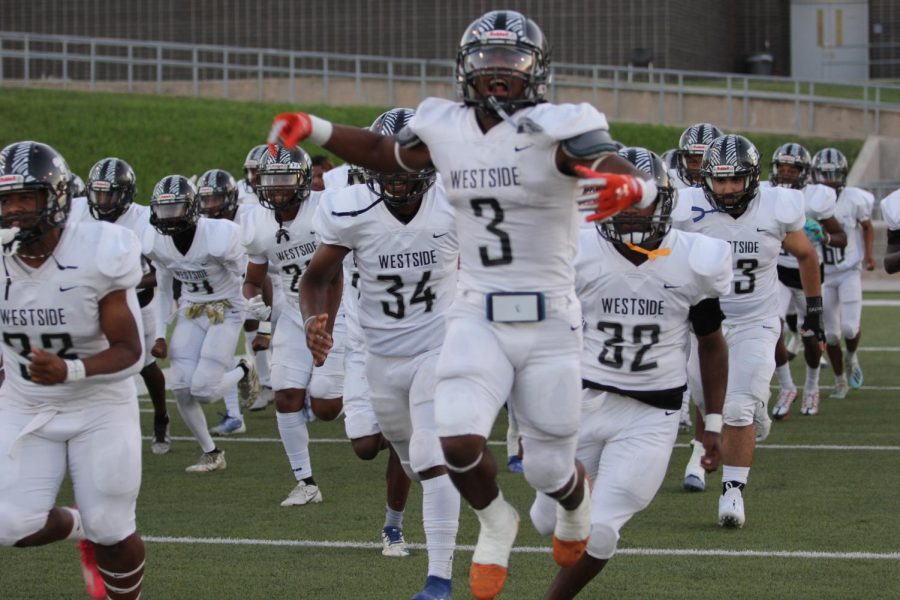 Wolves take the field, led by All District senior #3 Jahbari Kuykendall.